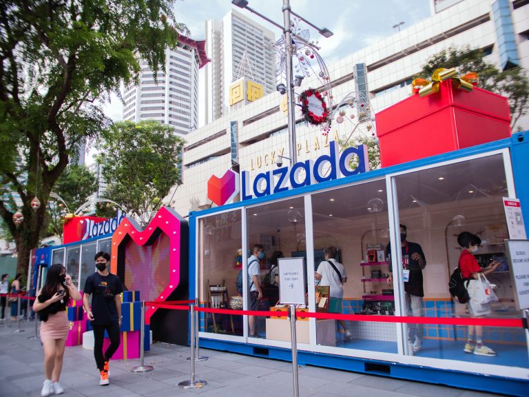 Lazada Festive Pop-Up booth in brand colours with visitors checking it out