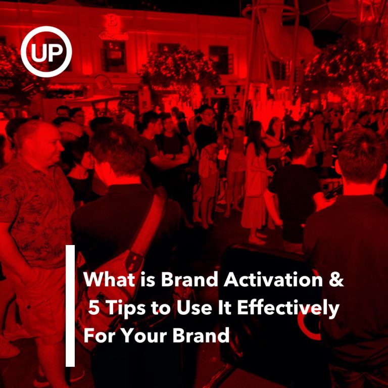 Text what is brand activation & 5 tips to use it effectively for your brand on a red filtered photograph of people partying at Clarke Quay